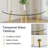 A modern minimalist style round transparent tempered glass table with gold metal legs