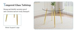 A modern minimalist style round transparent tempered glass table with gold metal legs