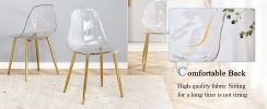 A modern minimalist style round transparent tempered glass table with gold metal legs