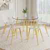 A modern minimalist style round transparent tempered glass table with gold metal legs