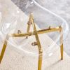 A modern minimalist style round transparent tempered glass table with gold metal legs