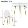 A modern minimalist style round transparent tempered glass table with gold metal legs
