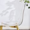 A modern minimalist style round transparent tempered glass table with gold metal legs